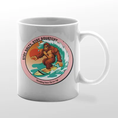 White mug with Bigfoot surfing graphic